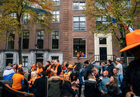 Amsterdam, Netherlands - 27 April, 2017: Streets of Amsterdam with orange decorations and dutch...