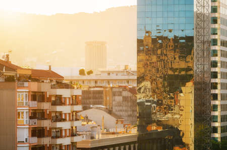 View of glass skyscrapers with reflection on Carrer de Tarragona Street near Spain square at sunset. Barcelona, Catalonia, Spain.の写真素材