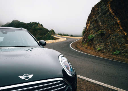 Taganana, Tenerife, Spain - May 31, 2017: Car close-up is on winding road im mist on north of...