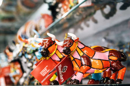 Barcelona, Catalunia, Spain - May 30, 2015: Multicolored mosaic figurine of bull in Gaudi style. Spanish traditional gifts in the souvenir shop.のeditorial素材