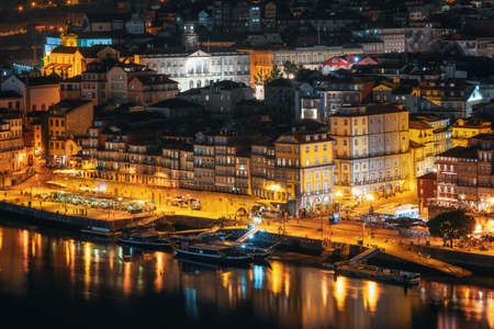 Porto cityscape. Embankment Douro River with bars, restaurants and active nightlife at night, Portugalの写真素材