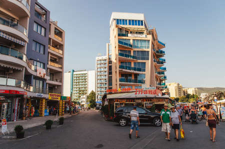 SUNNY BEACH, BULGARIA - AUGUST 29, 2015: Tourists walk along the promenade of Sunny Beach with numerous cafes, bars, restaurants and souvenirs shops.のeditorial素材