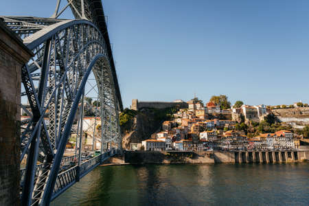 Old town of Porto on Douro River and Dom Luis I bridge in evening, Portugal.の写真素材