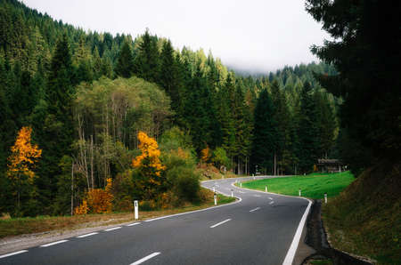 Winding road in dense forest in area of Dachstein massif in Alps, Austriaの写真素材