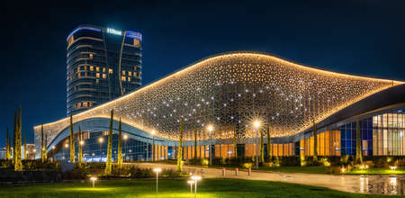 Tashkent, Uzbekistan - 30 October, 2019: Congress hall and Hilton hotel with colorful illumination at night in Tashkent City Parkのeditorial素材