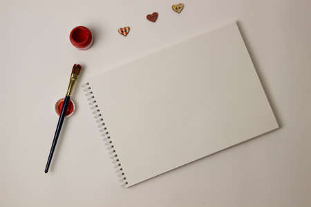 open album for drawing, red paint and brush. gouacheの写真素材