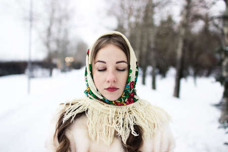 a girl in a Pavlopassadsky scarf is standing with her eyes closedの写真素材