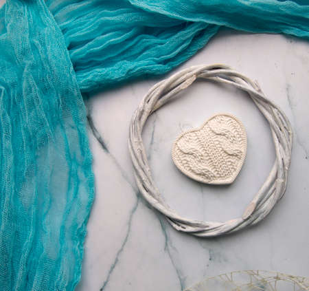 layout on a light marble background, a blue bluff, a ribbon and a woven round frame, a white gypsum...