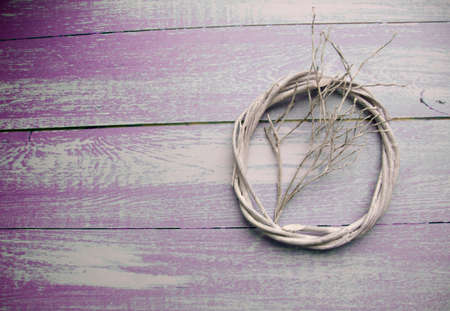 Wooden frame with a branch inside on a wooden background toned in the color of ultraviolet. view from above. top view. flatlayの写真素材