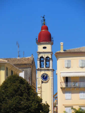 Beautiful bell tower of St. Spyridon's Cathedral on the small street of Corfu. Greece.の写真素材