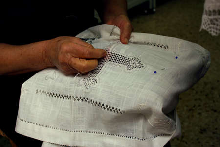 A close up view of an old woman's hands, embroidering Lefkara Lace or 'Lefkaritika' a traditional...