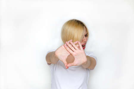 Woman with her hand extended signaling to stop (only her hand is in focus)の写真素材