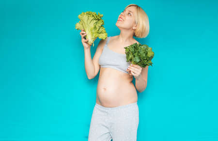 Woman in pregnant eating healthy vegetables salad ??? spinachの写真素材