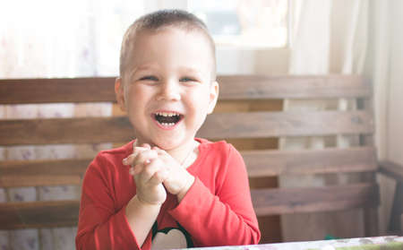 Happy boy laugh looking at camera portraitの写真素材