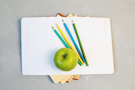 open book and a green apple back to school conceptの写真素材