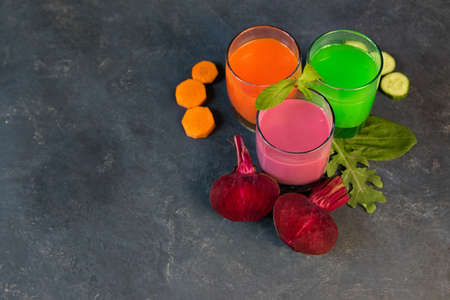 Healthy vegetable smoothie and juice on grey backround. Fresh
