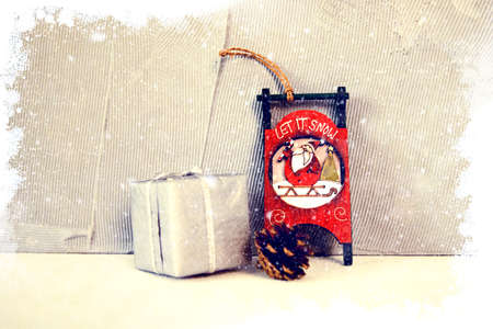 Xmas concept with wooden sled and santa sack with giftの写真素材