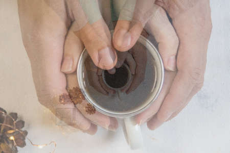 Couple in love holding hands with coffee on white marble table. Photograph taken from above, top...
