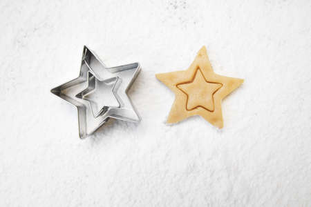 christmas gingerbread cookies with cutter , dough and rolling pin, full frame