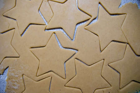 Cooking Christmas gingerbread cookies on a grey backgroundの写真素材