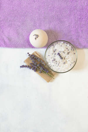 Natural herbal sea salt with aromatic lavender - perfect for relaxation. Cosmetic jars and bottles with salt, lavender flowers, bath bombの写真素材