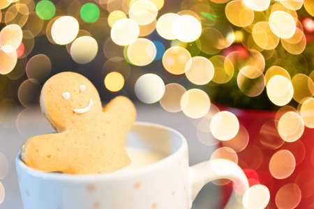Gingerbread cookie men in a hot cup of cappuccino