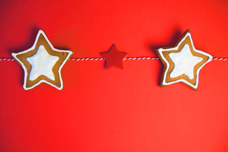 A row of three star cookies. Cookies tied a red ribbon. This fine handcrafted and painted by hand....