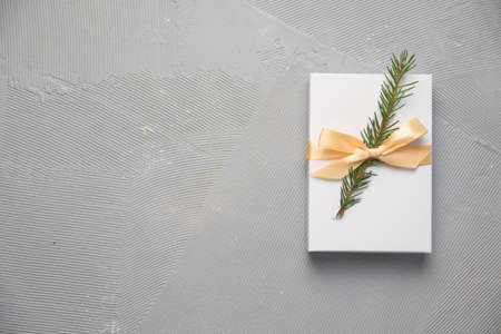 Christmas Gifts in White Box with light Ribbon on grey Background. New Year Holiday Composition Banner. Copy Space For Your Textの写真素材