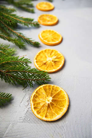 Christmas Tree Pine Branches with oranges on a light background.の写真素材