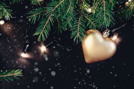 Fir tree branch with christmas decor covered with snow. Isolated on white backgroundの写真素材