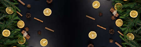 Christmas Tree Pine Branches with dry oranges. cinnamon, anise on a dark background.の写真素材