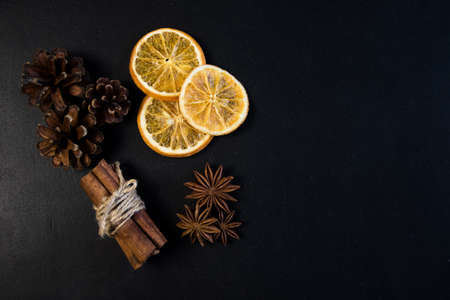 Christmas Tree Pine Branches with dry oranges. cinnamon, anise, pine on a dark background.の写真素材
