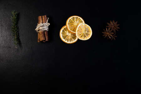 Christmas Tree Pine Branches with dry oranges. cinnamon, anise, pine on a dark background.の写真素材