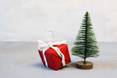 Red Christmas balls,gift boxes and fir tree on snow