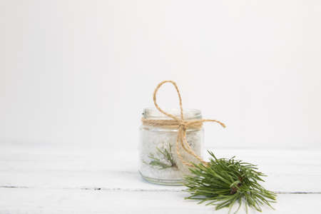 Natural herbal sea salt with aromatic fir - perfect for relaxation. Cosmetic jars and bottles with...