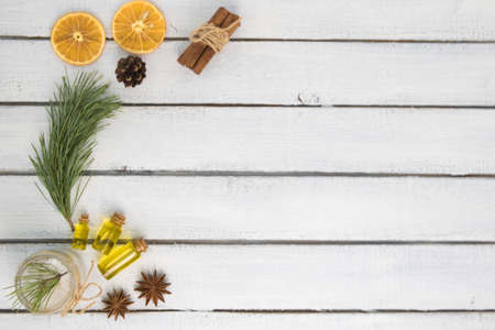 body oil in small jars on a background of pine branches