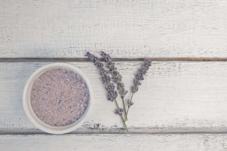 Natural herbal sea salt with aromatic lavender - perfect for relaxation. Cosmetic jars and bottles with salt, lavender flowers, bath bombの写真素材