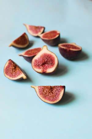 Fresh fig. Fruit with half and quarter isolated on blue background. Collection.の写真素材