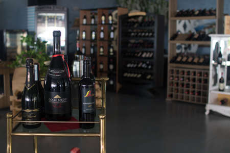 Resting wine bottles stacked on wooden racks in cellarのeditorial素材