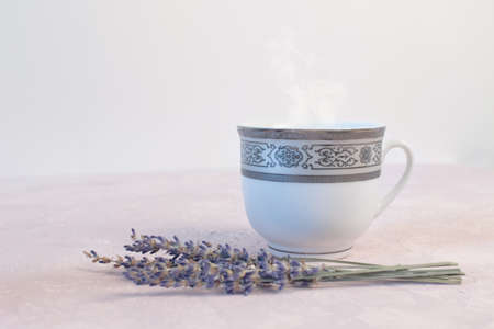 Coffee and lavender flower on pink table from above. Woman working desk. Cozy breakfast. Mockup. Flat lay styleの写真素材