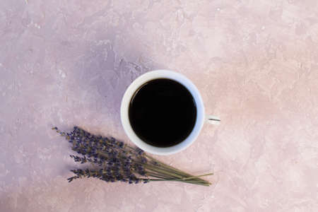 Coffee and lavender flower on pink table from above. Woman working desk. Cozy breakfast. Mockup. Flat lay styleの写真素材