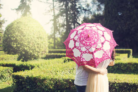 Silhouette of young couple behind umbrella in a forestの写真素材