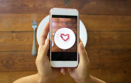 Raspberries fruit Heart on a white background. Fresh organic and ripe love symbol. Summer timeの写真素材