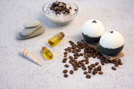 Aromatherapy and spa concept. Spa salt with coffee scent near soap, spa oil and loofah on white background top viewの写真素材
