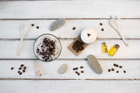 Aromatherapy and spa concept. Spa salt with coffee scent near soap, spa oil and loofah on white background top viewの写真素材