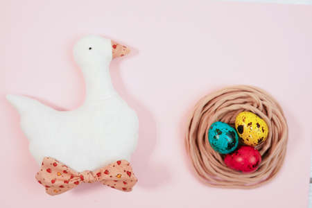 Colored quail eggs in the nest. Easter.の写真素材