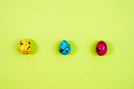 a row of colored painted quail eggs for Easter.の写真素材