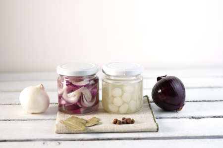 Glass Jar of Pickled Onions on White wood Backgroundの写真素材