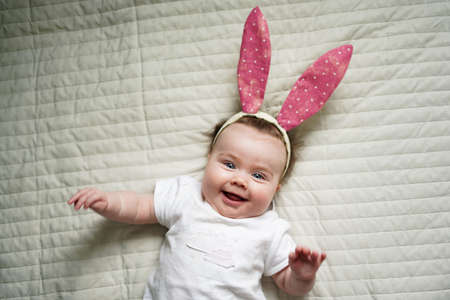 Like bunny rabbits. Cute children in Easter bunny style. Small children in Easter bunny headbands. Little children wearing Easter bunny ears. Happy children celebrating Easterの写真素材