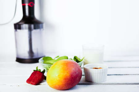 Components of healthy Green Reach Vitamins Smoothie with baby leaf spinach, mango, almond milk and strawberryの写真素材